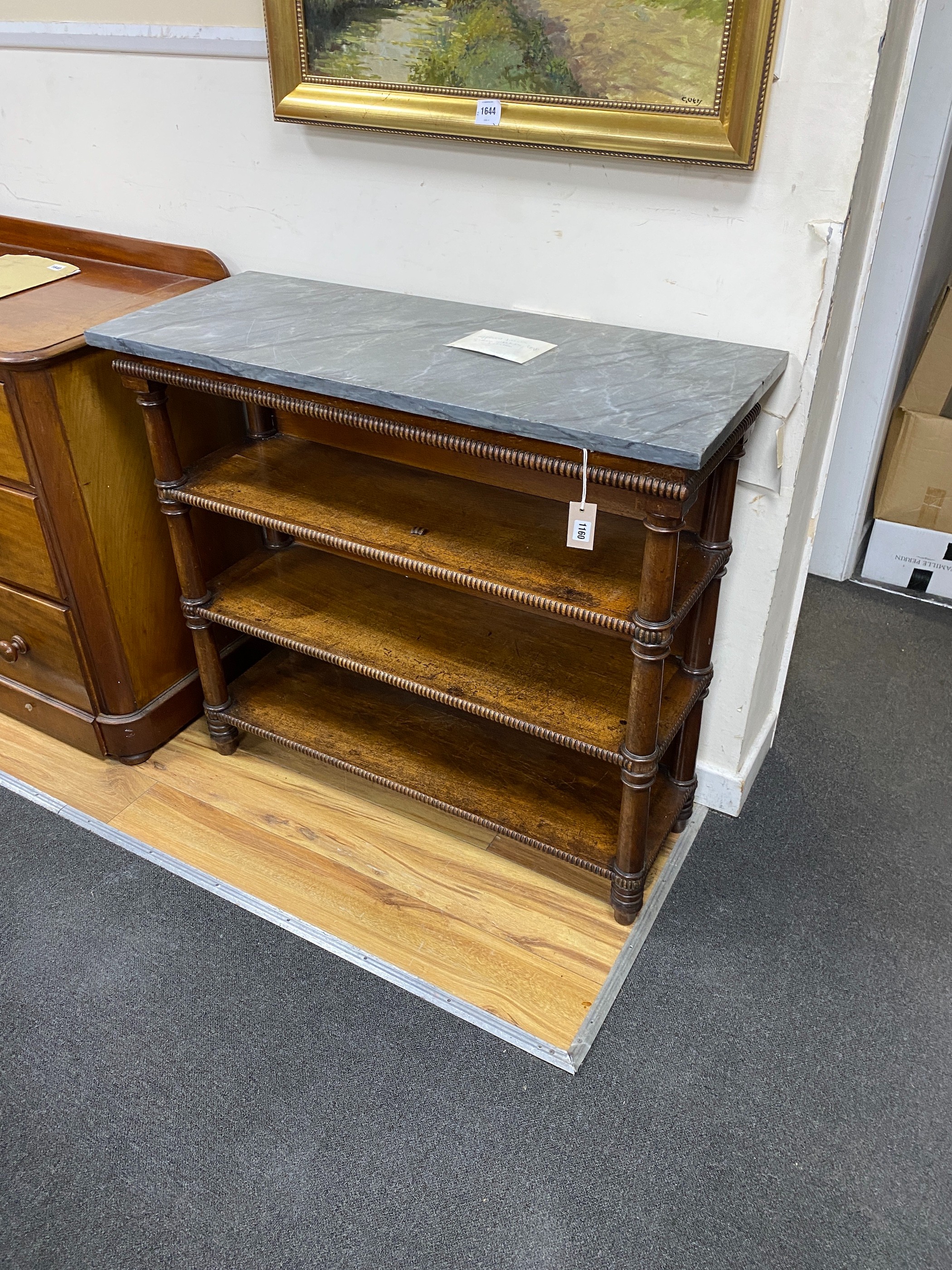 An early Victorian later marble topped mahogany bookcase, length 103cm, depth 41cm, height 92cm